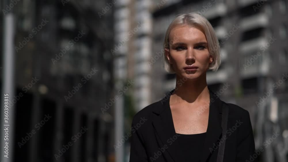 masculine woman or feminine gay is walking on city street at summertime masculine woman or feminine gay is walking on city street at summertime