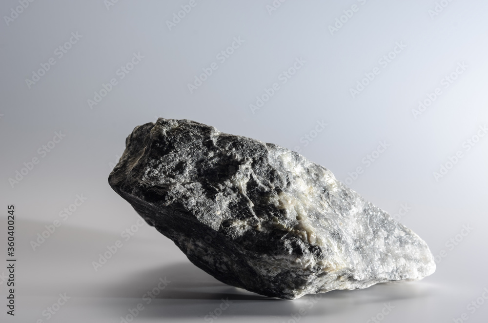 a piece of granite stone on a light gray background a piece of granite stone on a light gray background