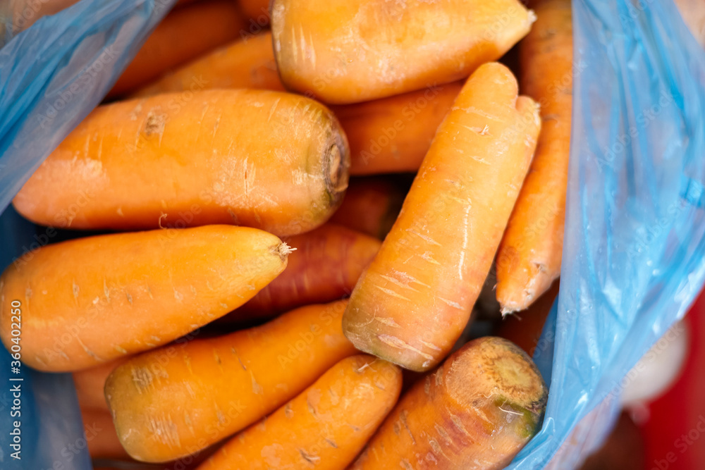 Pile of fresh organic carrots. Healthy eating. Purchasing fresh vegetables in the market Pile of fresh organic carrots. Healthy eating. Purchasing fresh vegetables in the market