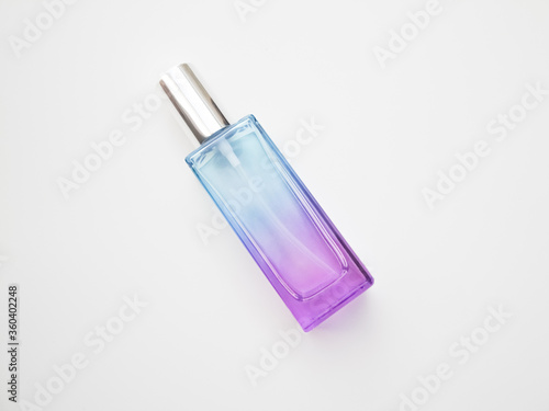 Blue glass bottle on a purple background. Card with copy space for text. Top view, flatlay