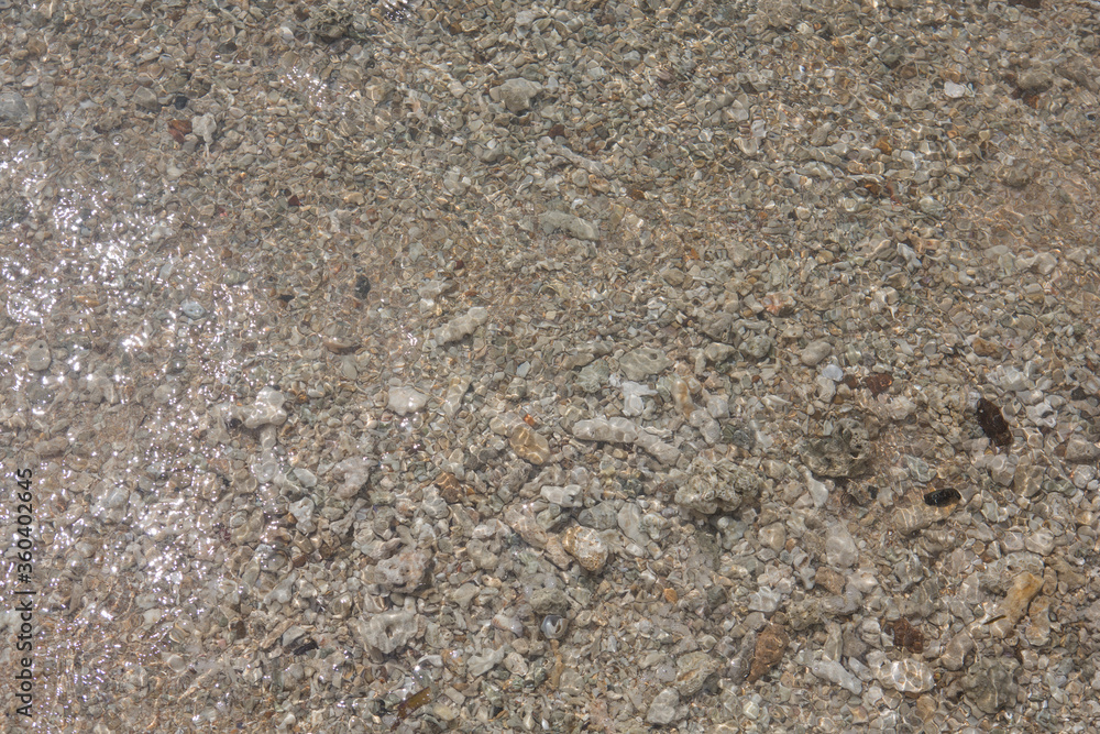 natural filled frame close up background wallpaper of a wet brown beige gravel beach rocks and stones surface natural filled frame close up background wallpaper of a wet brown beige gravel beach rocks and stones surface