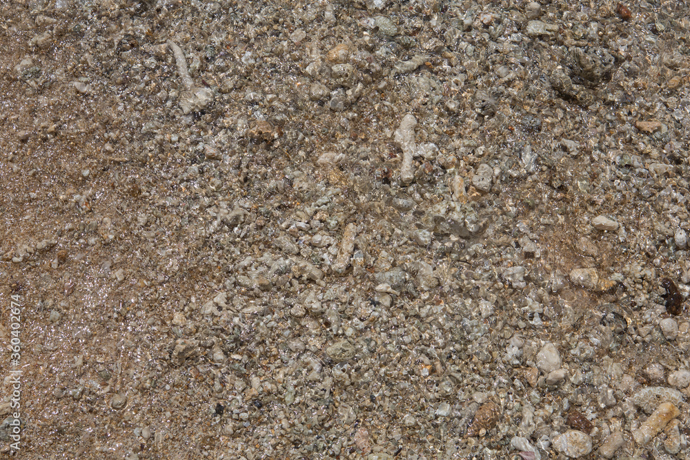 natural filled frame close up background wallpaper of a wet brown beige gravel beach rocks and stones surface natural filled frame close up background wallpaper of a wet brown beige gravel beach rocks and stones surface