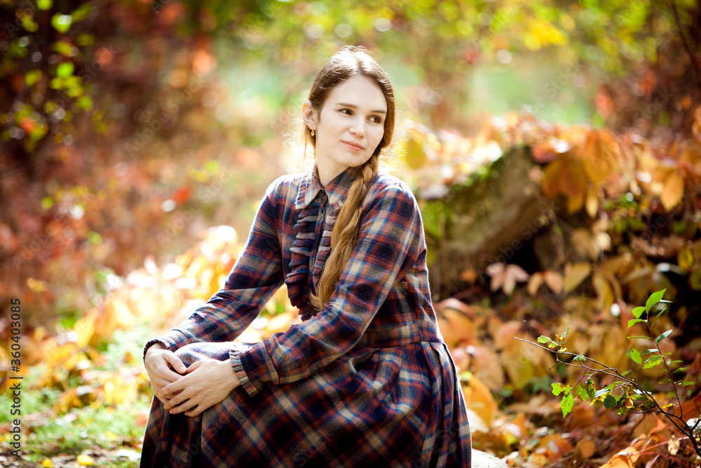 woman in plaid dress in autumn forest. nature walks. woman in plaid dress in autumn forest. nature walks.