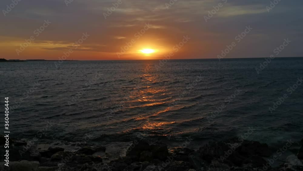 Orange sunset over the sea 4K. Calm sea waves in the last rays of the sun. Relaxation and peace. Orange sunset over the sea 4K. Calm sea waves in the last rays of the sun. Relaxation and peace.