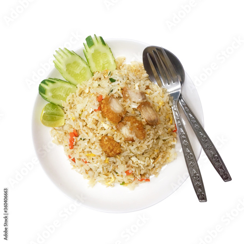 Fried rice with crispy pork served with cucumber and lime on white plate, isolated on white background. Ingredients include jasmine rice, carrot, egg, spring onion and crispy pork.
