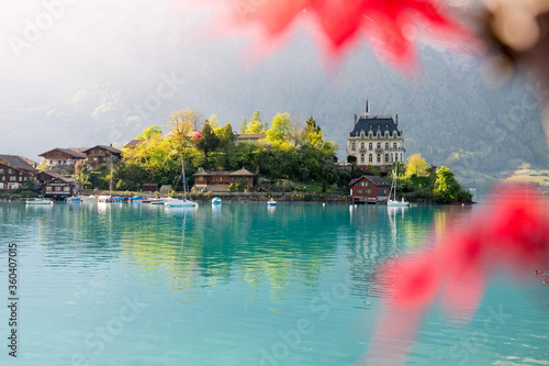 view of Schloss Seeburg, Iseltwald in turquoise Lake Brienz