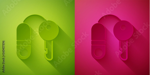 Paper cut House with key icon isolated on green and pink background. The concept of the house turnkey. Paper art style. Vector Illustration.