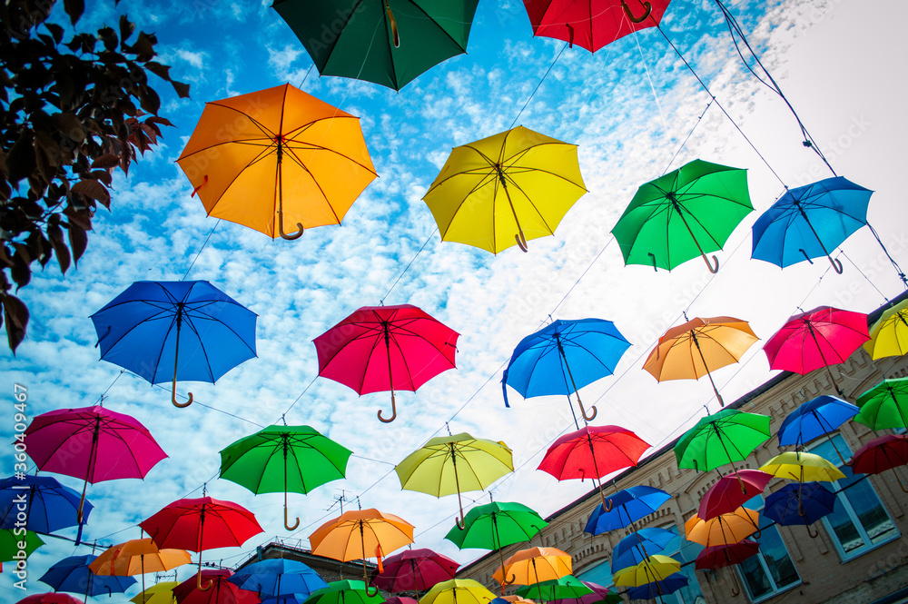Multi colored umbrellas with blue sky