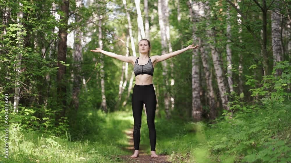 Sporty woman practicing yoga lesson, workout in summer park doing exercise outdoor. Sporty woman practicing yoga lesson, workout in summer park doing exercise outdoor.