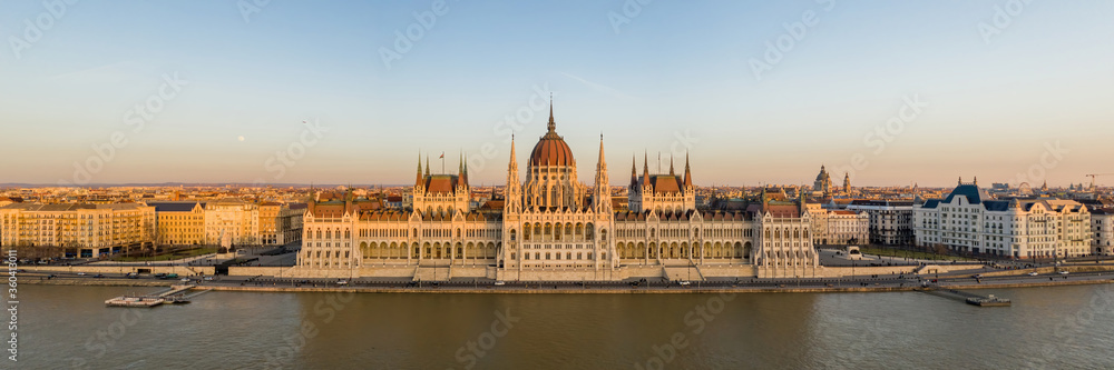 Panorama aerial drone shot of Hungarian Parliament facade during Budapest sunset