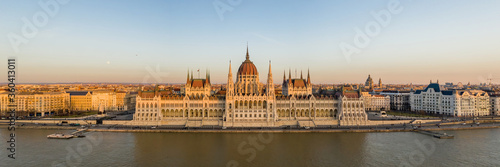 Panorama aerial drone shot of Hungarian Parliament facade during Budapest sunset