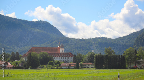 Schlehdorf Abbey and the hydroelectric power station Walchensee in the alpine hills in background (Bavaria, Germany)