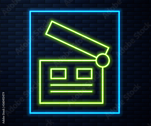 Glowing neon line Movie clapper icon isolated on brick wall background. Film clapper board. Clapperboard sign. Cinema production or media industry. Vector Illustration.