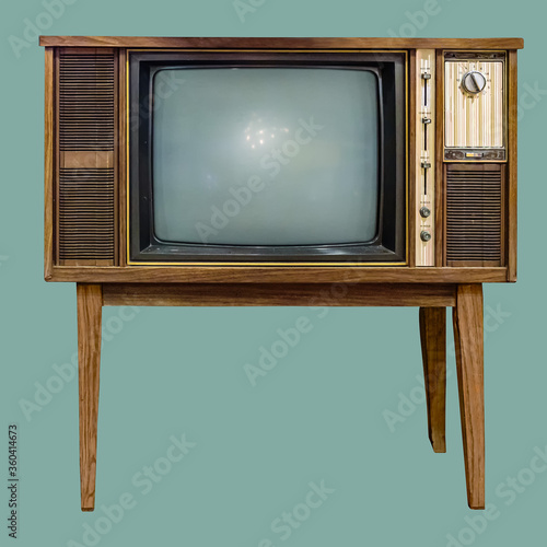 Vintage TV : old retro TV set in wooden cabinet on isolated green background with clipping path.