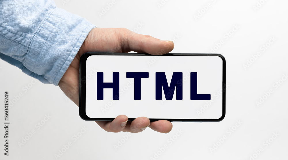 Man's hand holding smartphone with text HTML on white background Man's hand holding smartphone with text HTML on white background
