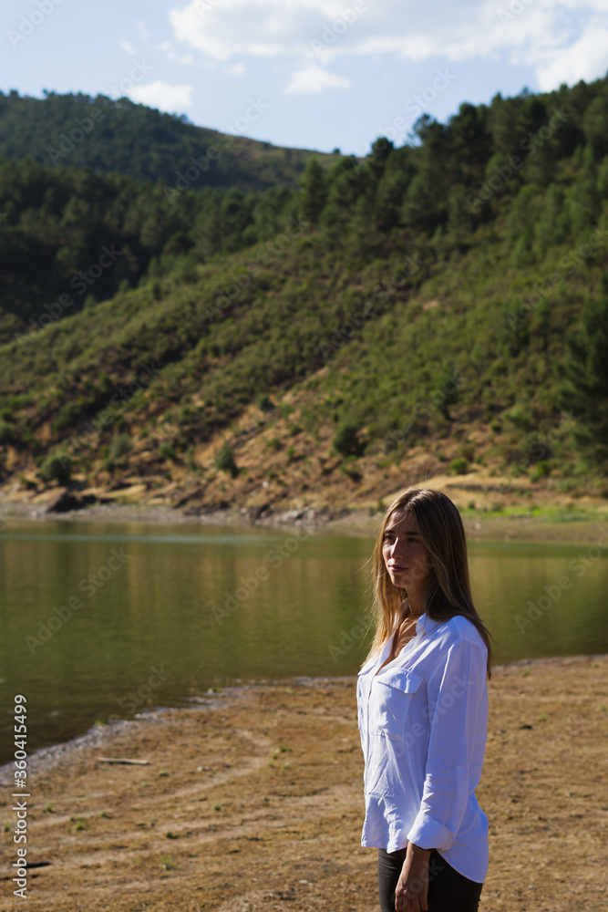 Beautiful woman with long hair on the background of nature seeing the lake. Melero Meander, Batuecas National Park Beautiful woman with long hair on the background of nature seeing the lake. Melero Meander, Batuecas National Park