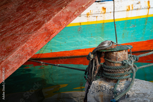 Two colorful ships docked at a local harbour in Jakrata, Indonesia.