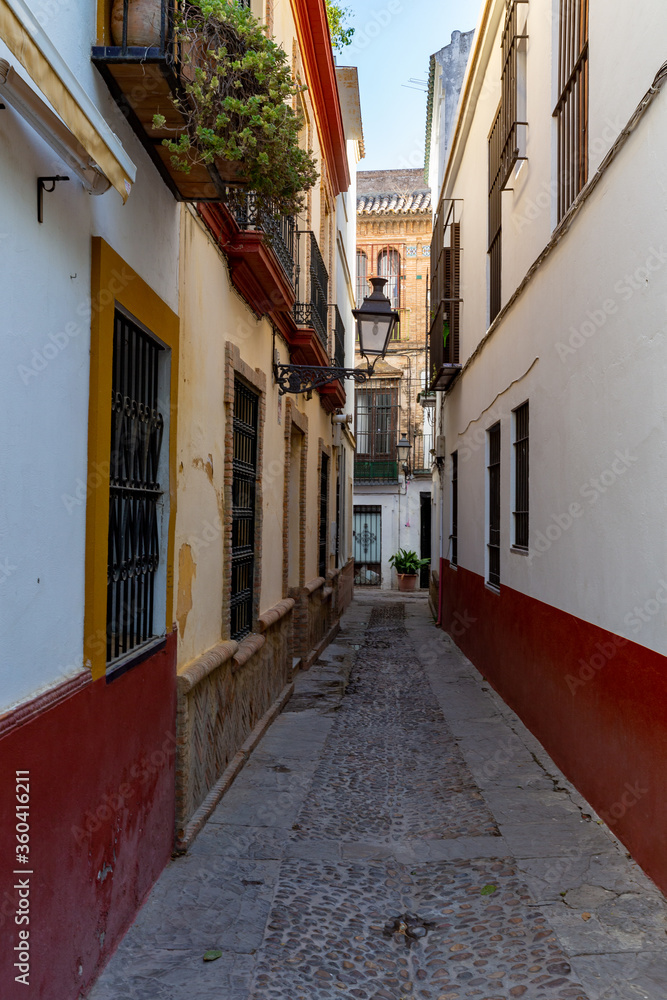 Narrow alley in the Old Town of Seville, Andalucia, Spain.