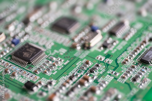 Detail of an electronic printed circuit board with many electrical components with narrow depth of field.