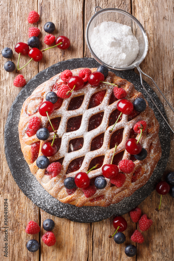 berry pie mix with raspberries, blueberries and cherries close-up on a slate board. vertical top view berry pie mix with raspberries, blueberries and cherries close-up on a slate board. vertical top view