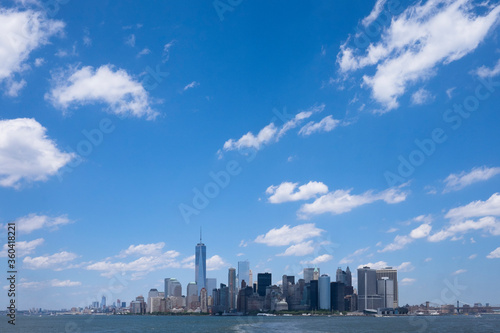 Skyline of downtown Manhattan New York during daytime as seen from a boat. Space for text on sky. © Henk Vrieselaar