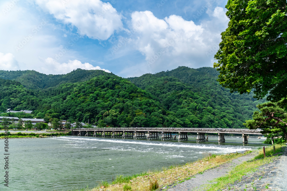 Togetsukyo Bridge in Arashiyama, Kyoto, Japan. vivid fresh greenery in early summer and the Katsuragawa river flowing vigorously.