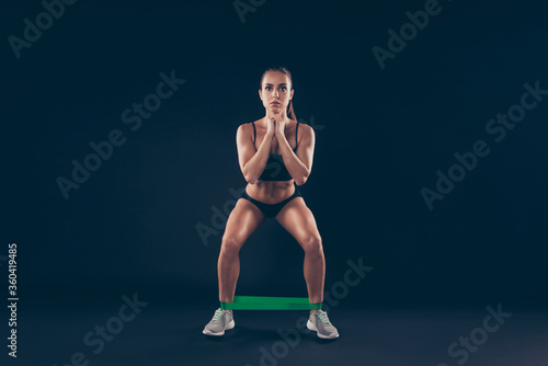 Portrait of her she nice-looking attractive sportive perfect strong slim thin adorable lady doing work out weight loss sit ups isolated over black background
