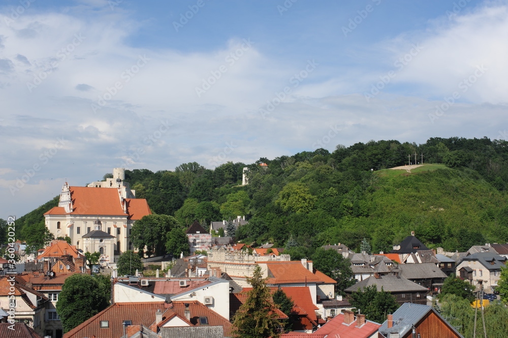 A panorama of beautiful picturesque medieval town Kazimierz Dolny in Poland with blue sky and clouds in summer