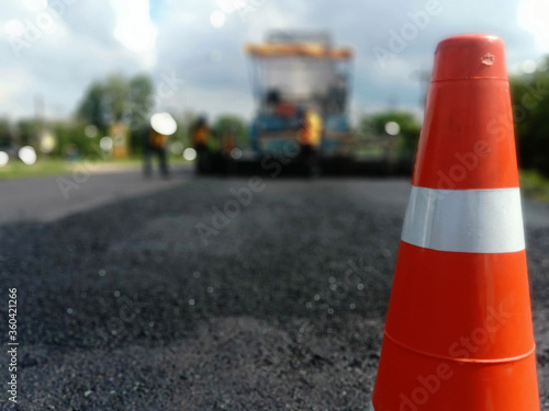 Blur image, asphalt road maintenance work And there is a red rubber cone in the front