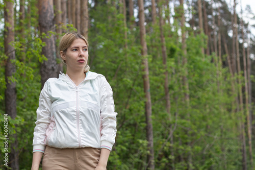 Young girl in the woods girl walks in the forest. Happy, outdoor.