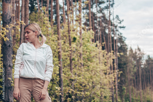 Young girl in the woods girl walks in the forest. Happy, outdoor.