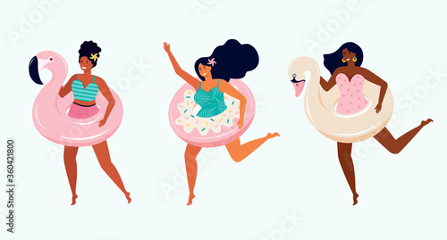 Happy women in swimsuits with inflatable float donut, swan and pink Flamingo. Girlfriends have fun on summer holidays by the sea. Beach party. Toys for swimming in the pool. Female friendship.