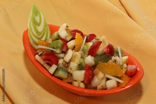 Fresh Fruit Salad in Red Bowl on Dark Background