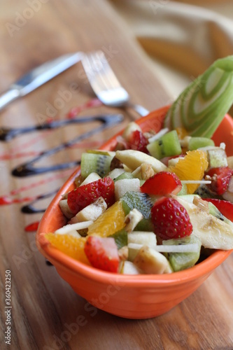 Fresh Fruit Salad in Red Bowl on Dark Background