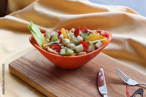 Fresh Fruit Salad in Red Bowl on Dark Background