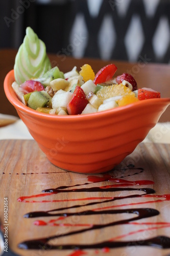 Fresh Fruit Salad in Red Bowl on Dark Background