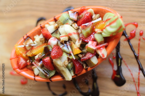 Fresh Fruit Salad in Red Bowl on Dark Background