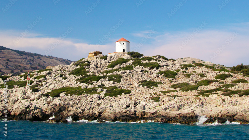 Windmill on the shore, Symi island, Panormitis, Greece