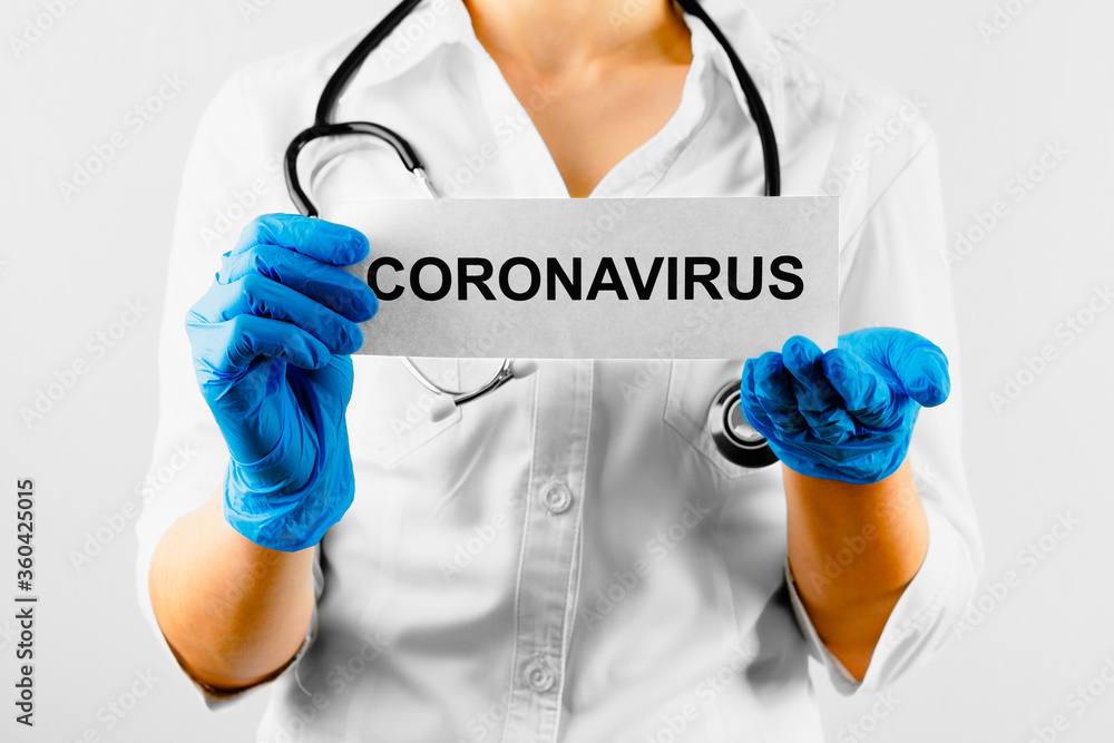 Coronavirus, white card with the text Coronavirus in doctor hands in white coat and gloves. Coronavirus, white card with the text Coronavirus in doctor hands in white coat and gloves.