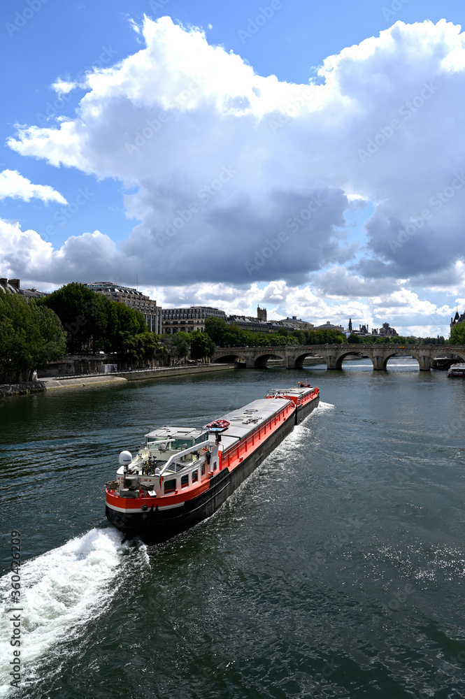 Obraz premium Long red barge on the Seine river in Paris