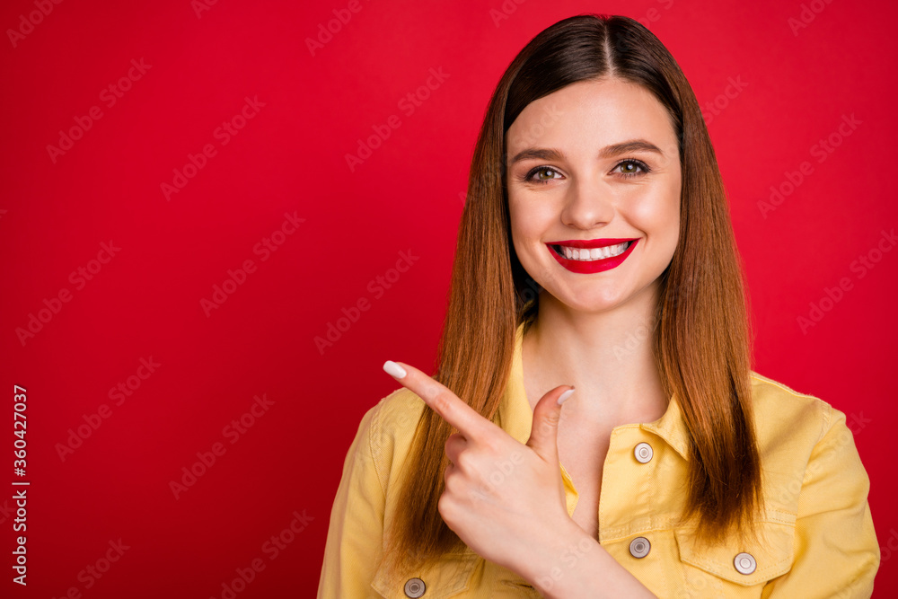Closeup photo of attractive lady good mood direct fingers side empty space showing shopping low price product wear casual yellow blazer jacket isolated vivid red color background Closeup photo of attractive lady good mood direct fingers side empty space showing shopping low price product wear casual yellow blazer jacket isolated vivid red color background
