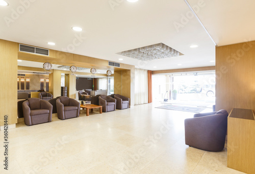 Mirror  watches  armchairs in interior of hotel hall