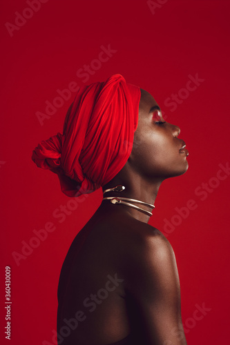 Quadro su tela Profile view of attractive woman wearing a red turban