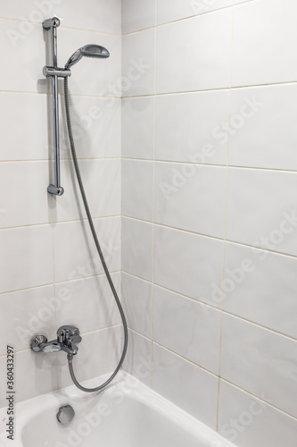 bathroom with shower and bathtub with white tiles