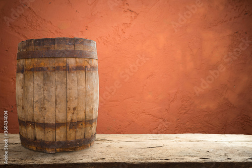 Wooden barrel on a table and textured background