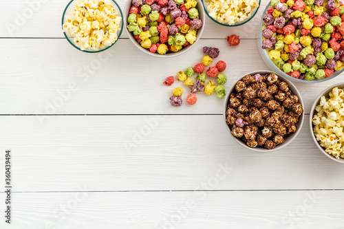 Bild auf Leinwand Flavored popcorn on white background top view space for text