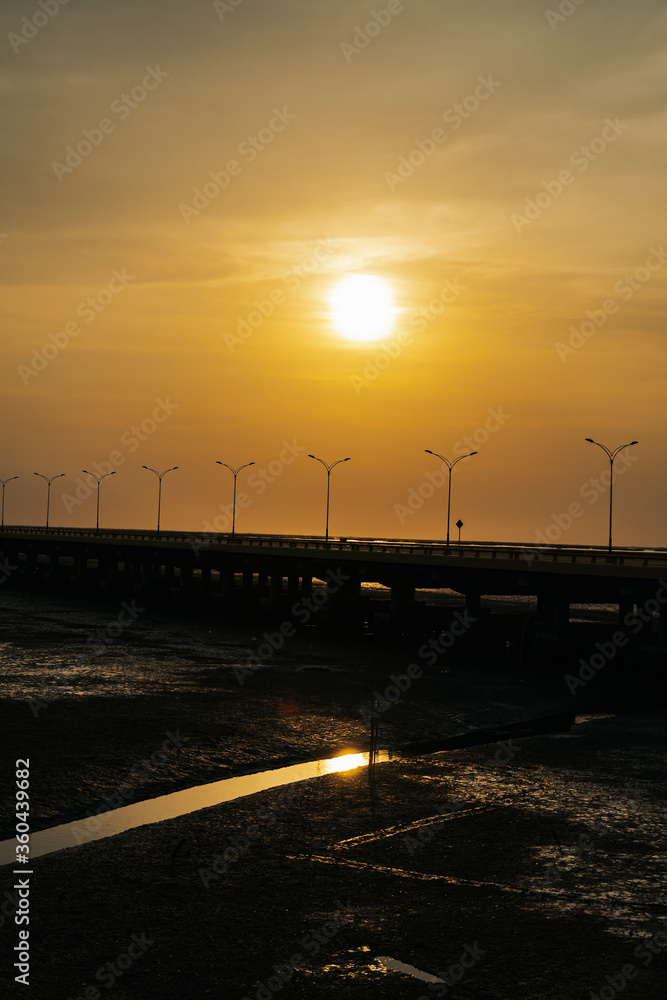 Sunset view on highway road over sea bridge in Thailand.
