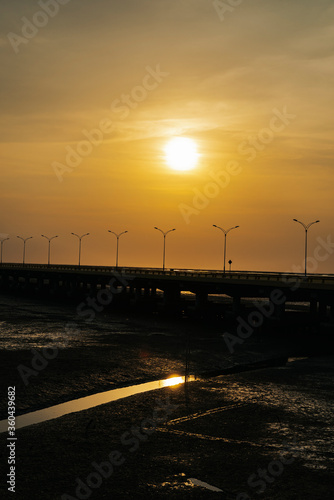 Sunset view on highway road over sea bridge in Thailand.