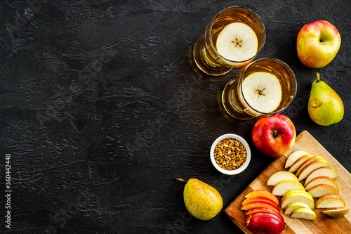 Fruit drinks with apple and pear on black table top-down copy space photo