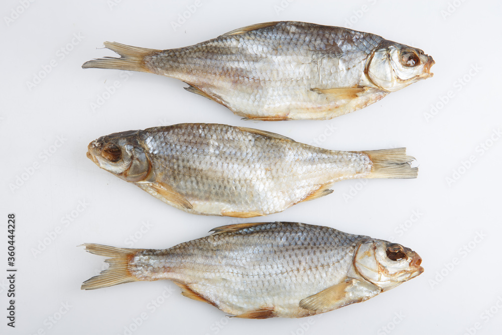 isolated close up top view shot of three Russian dried salted vobla (Caspian Roach) fish on a white background isolated close up top view shot of three Russian dried salted vobla (Caspian Roach) fish on a white background